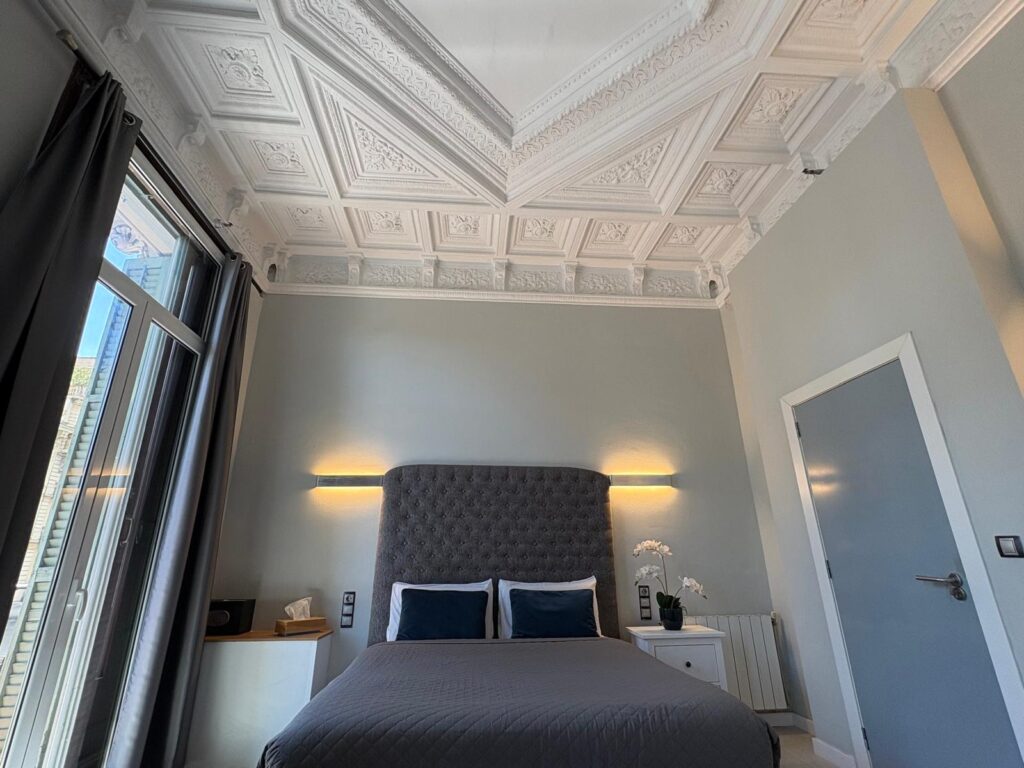 Spacious quadruple family room with private bathroom and balcony overlooking Plaça Catalunya at Hotel Ginebra Barcelona