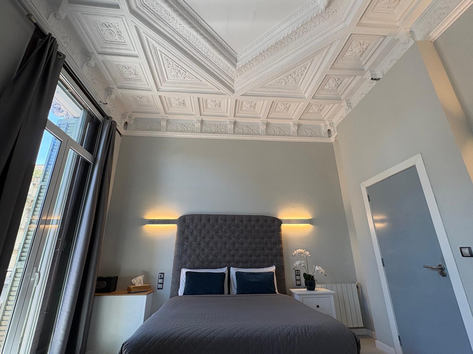 Spacious quadruple family room with private bathroom and balcony overlooking Plaça Catalunya at Hotel Ginebra Barcelona